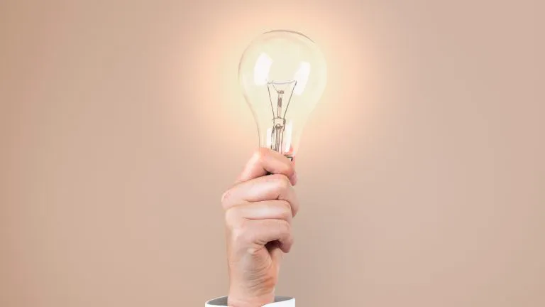 man holding a lightbulb to showcase brand recall
